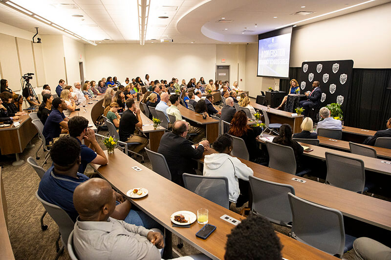 A crowd listens to Nancy Richards Farese speak at UWG event.