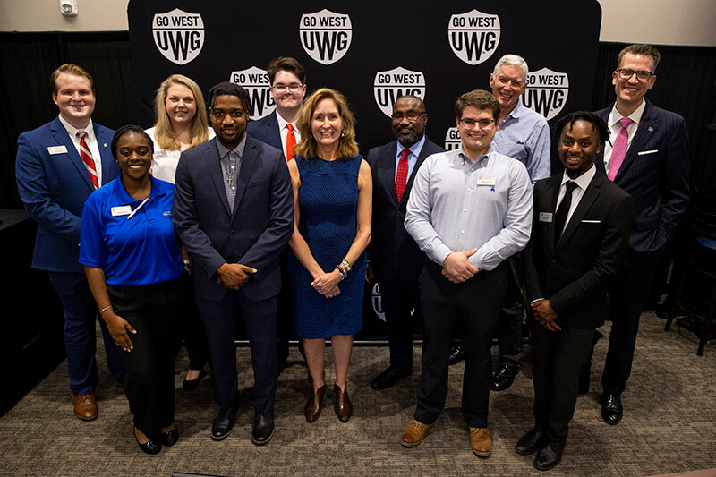 Nancy Richards Farese stands with community members at UWG event