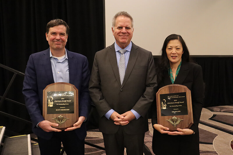 APEE President Daniel Houser of George Mason University (center) presented the Clark-Kent-Aronoff Award to Scott Niederjohn (left) and Kim Holder (right).
