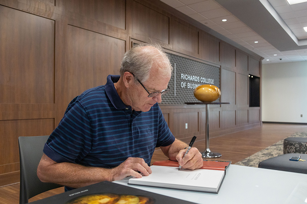 Philip Moulthrop signs his book.