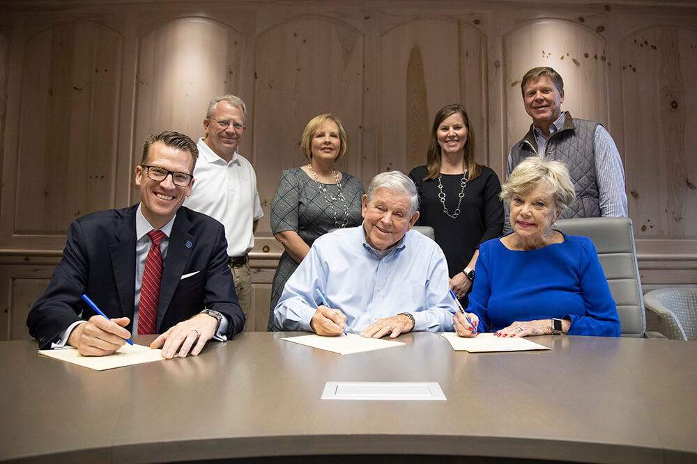 Front row: Dr. Brendan Kelly, UWG president; Bob Stone, founder of SMI; Tish Stone, Bob's wife. Back row: Bart Stone, SMI's chief properties officer; Robin Custard, chief financial officer; Karen Middlebrooks, chief administrative officer; and Bill Stone, president of SMI