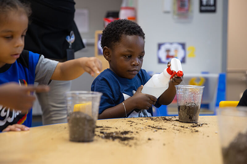 Three-year-old student playing in a UWG Head Start classroom