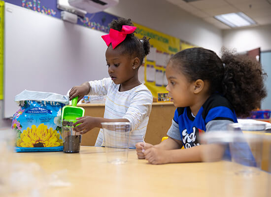 Two three-year-old children play in a UWG Head Start classroom