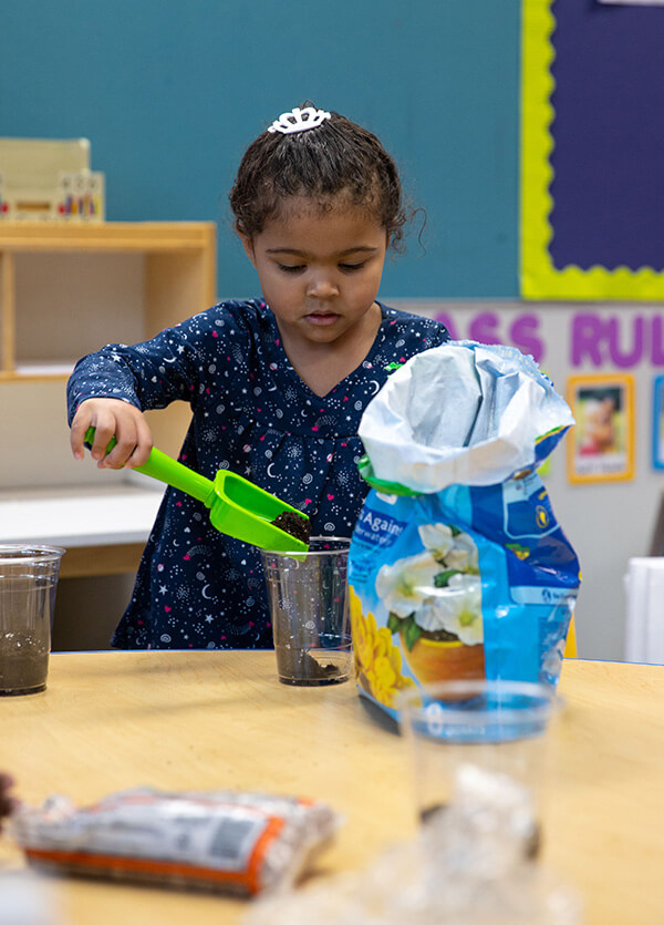 Three-year-old child playing in a UWG Head Start classroom