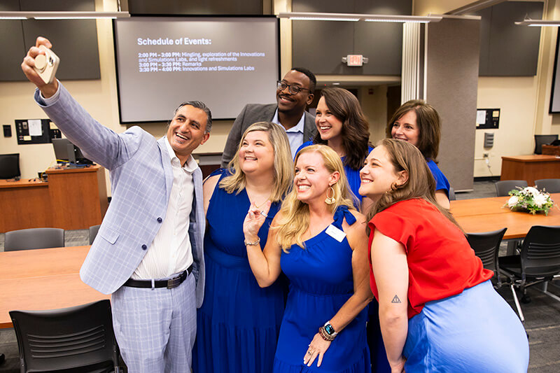 Dr. Ashwani Monga, interim UWG president, snapped a picture with celebrants
