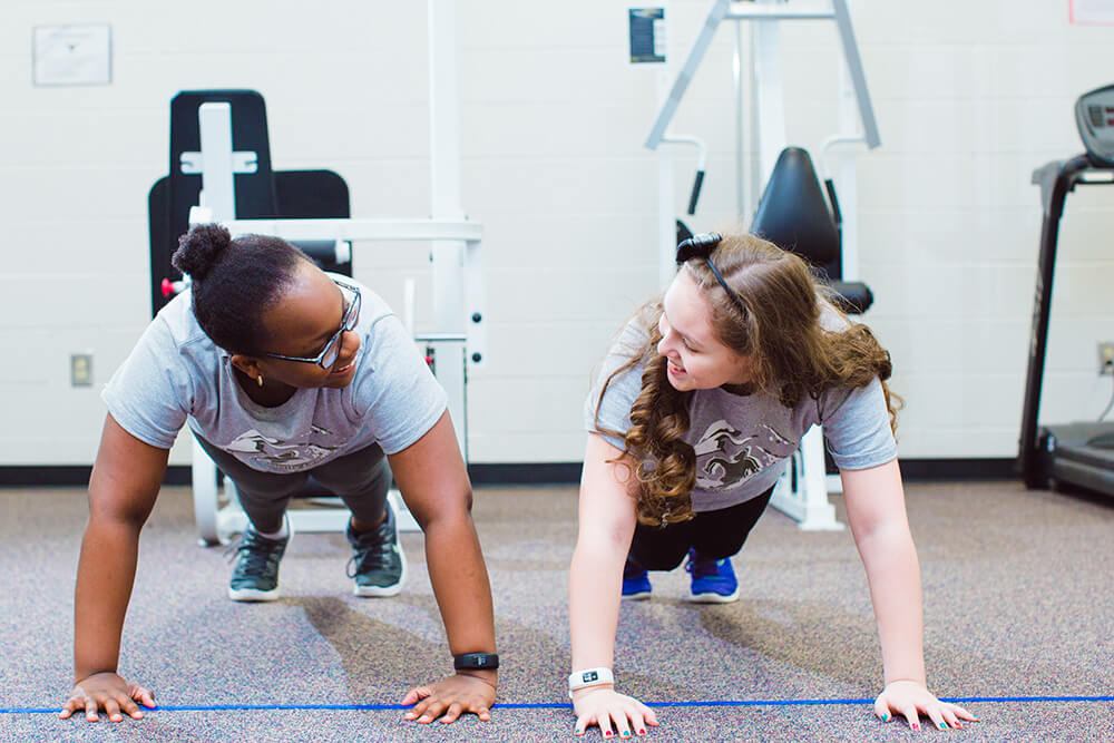 Two girls doing push ups