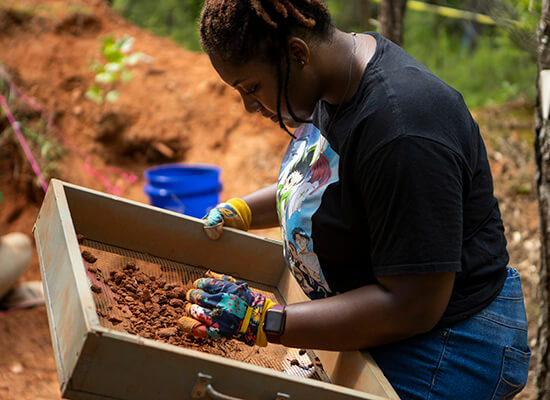 UWG anthropology student on a dig
