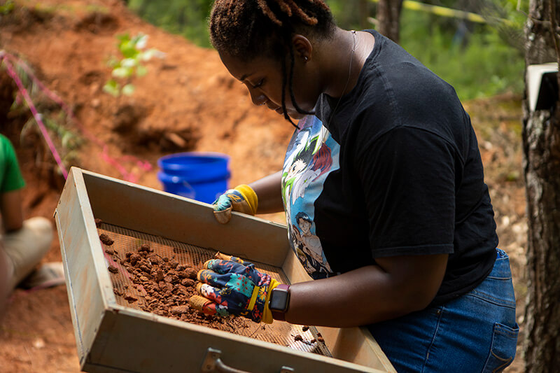 UWG anthropology student at a dig