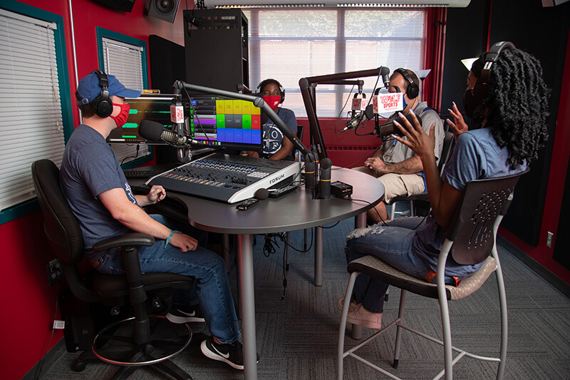 Students working at a campus radio station