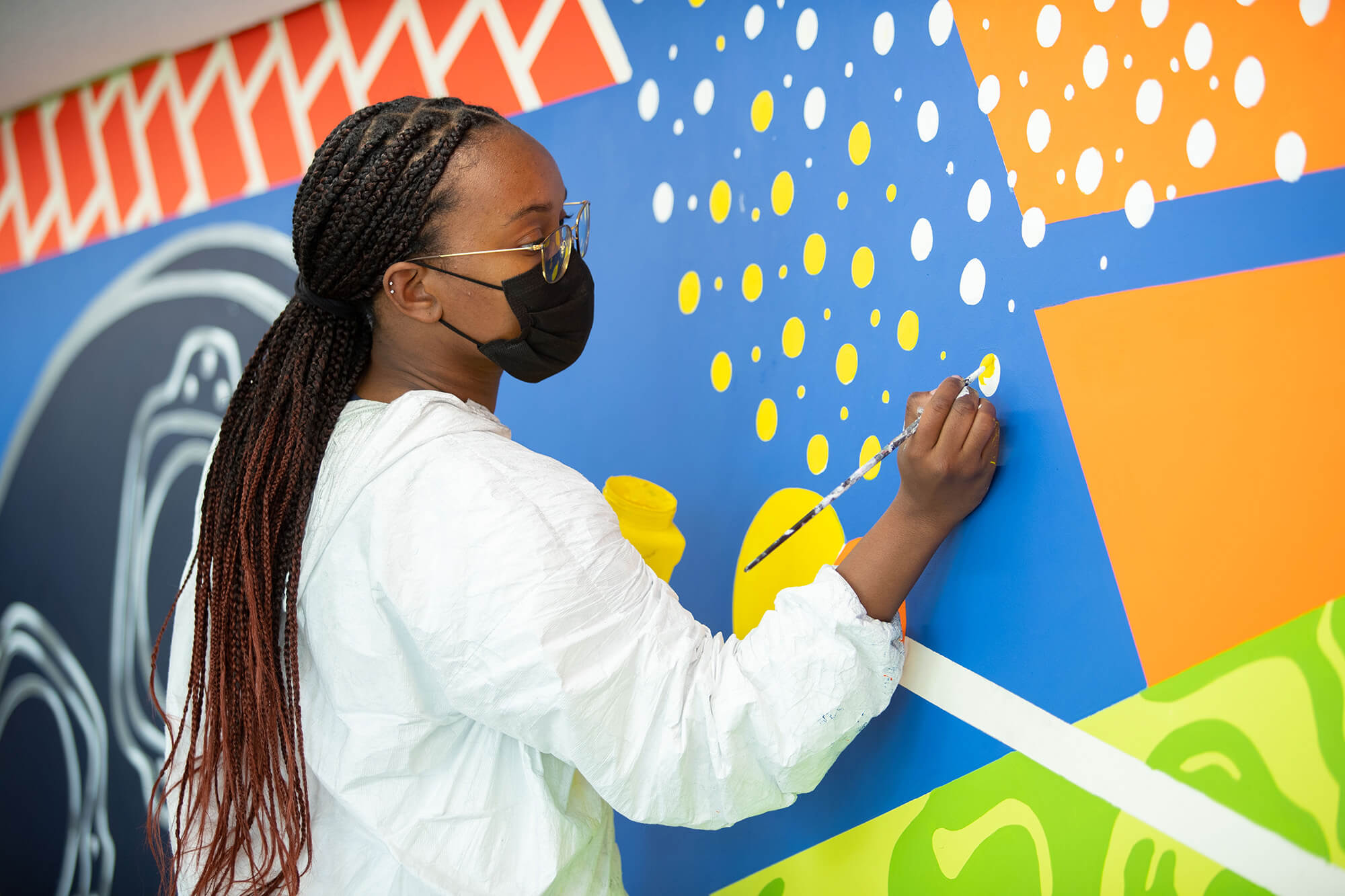 Ariana Culver works on a mural.