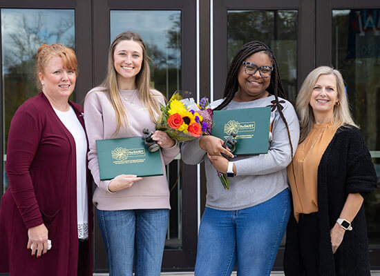 UWG students Emily Powell (left) and Dejah Shipman (right) receive their DAISY Awards.
