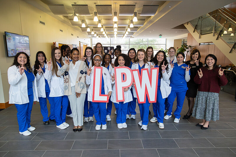 Group of UWG nursing students holding the letters LPW