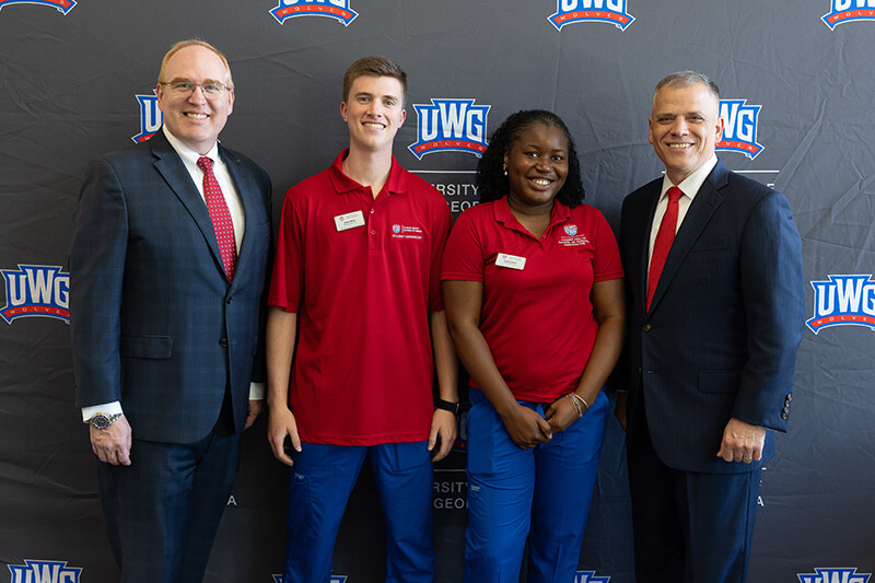 L to R: Dr. Jon Preston, UWG provost and senior vice president for academic affairs; Nathan Merritt, BSN student and nursing ambassador; Blessing Udoudu, BSN student and nursing ambassador; and Dr. Michael Johnson, UWG president
