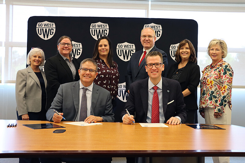 L to R, front row: Dr. Mike Hobbs, GHC president; Dr. Brendan Kelly, UWG president. L to R, back row: Dr. Paula Stover, GHC director of nursing; Dr. Lisa Jellum, GHC School of Health Sciences dean; Dr. Sarah Coakley, GHC provost and chief academic officer; Dr. Jon Preston, UWG provost and senior vice president for academic affairs; Dr. Jenny Schuessler, UWG Tanner Health School of Nursing dean; and Sally Richter, interim associate dean of UWG nursing graduate programs