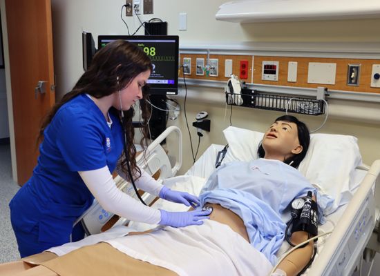UWG nursing student working with a manikin