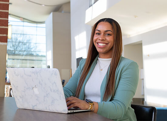 UWG student studying at a laptop