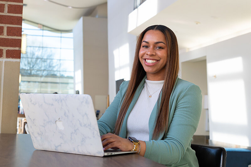 UWG student studying at a laptop