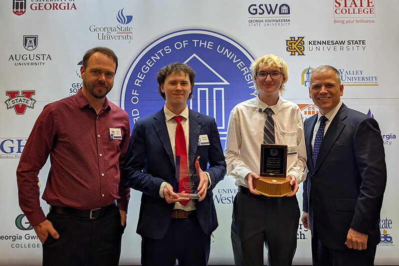 L to R: Justin Kirk, UWG Debate director; Bruce Bissell, UWG Debate; James Kennon, UWG Debate; Dr. Michael Johnson, UWG president