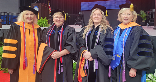 Doctoral graduate group photo at commencement.