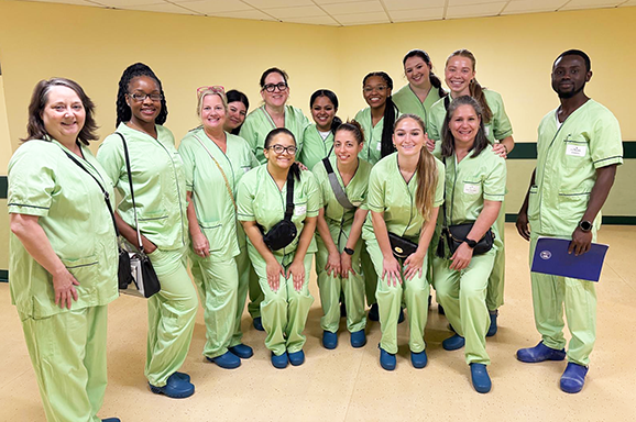 Group of nursing students and faculty wearing scrubs in an Italian hospital