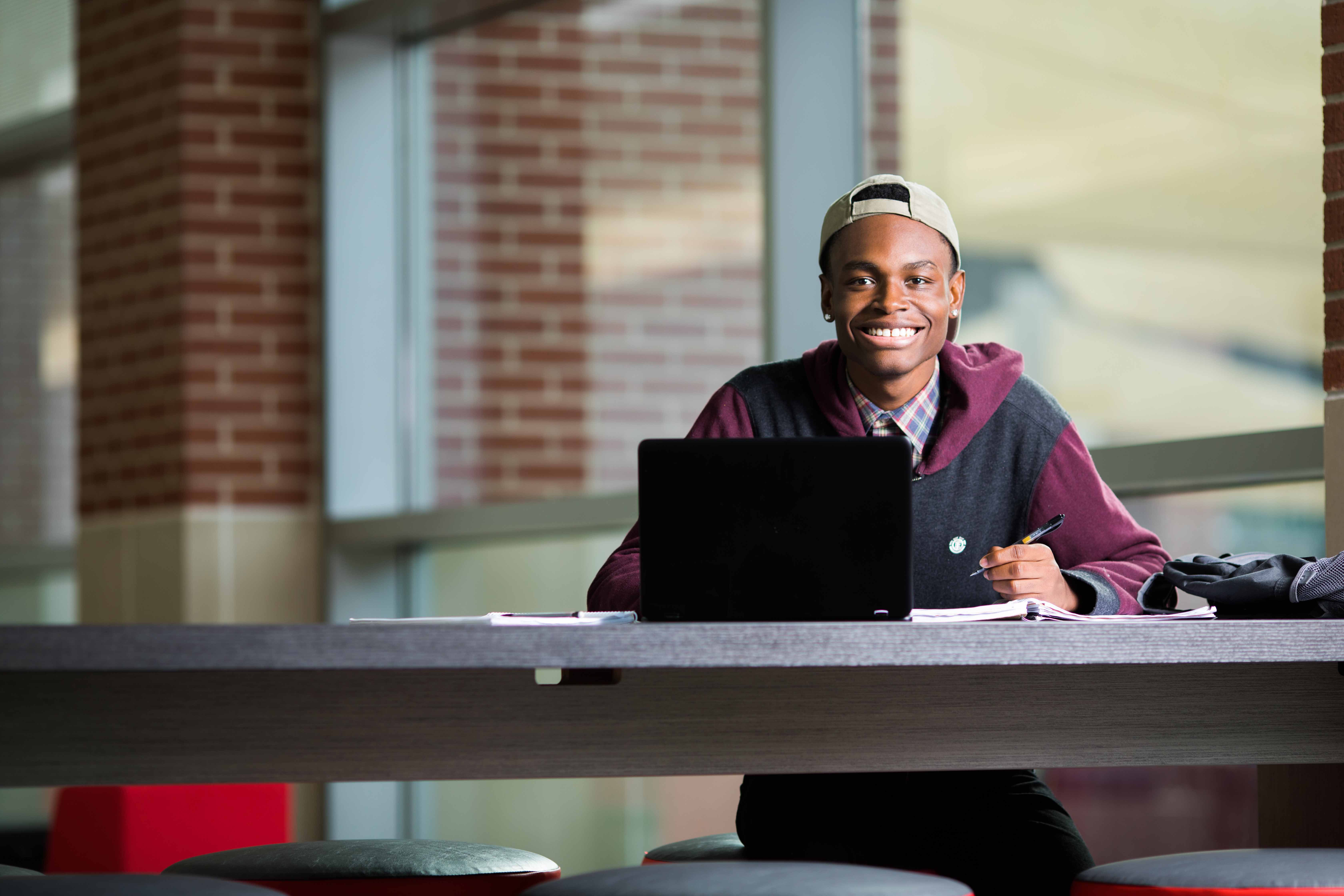 Student sitting with a computer in front of him