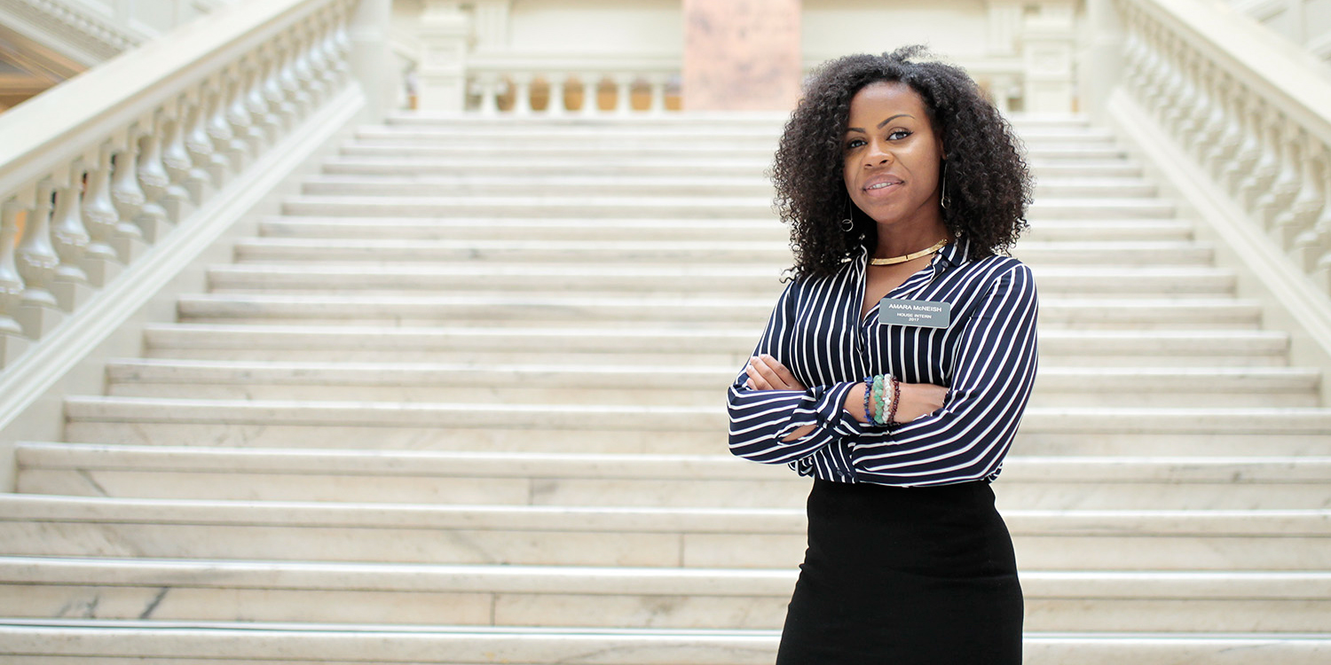 student on steps of government building