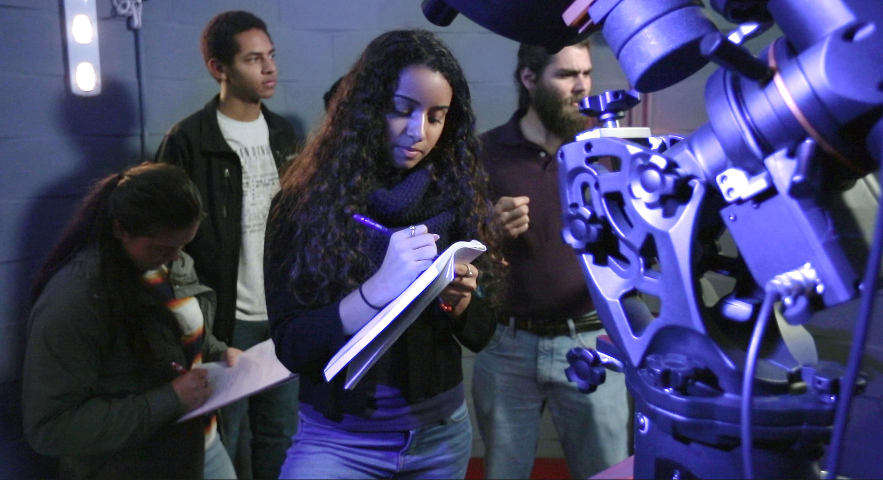 interior of observatory with telescope and students