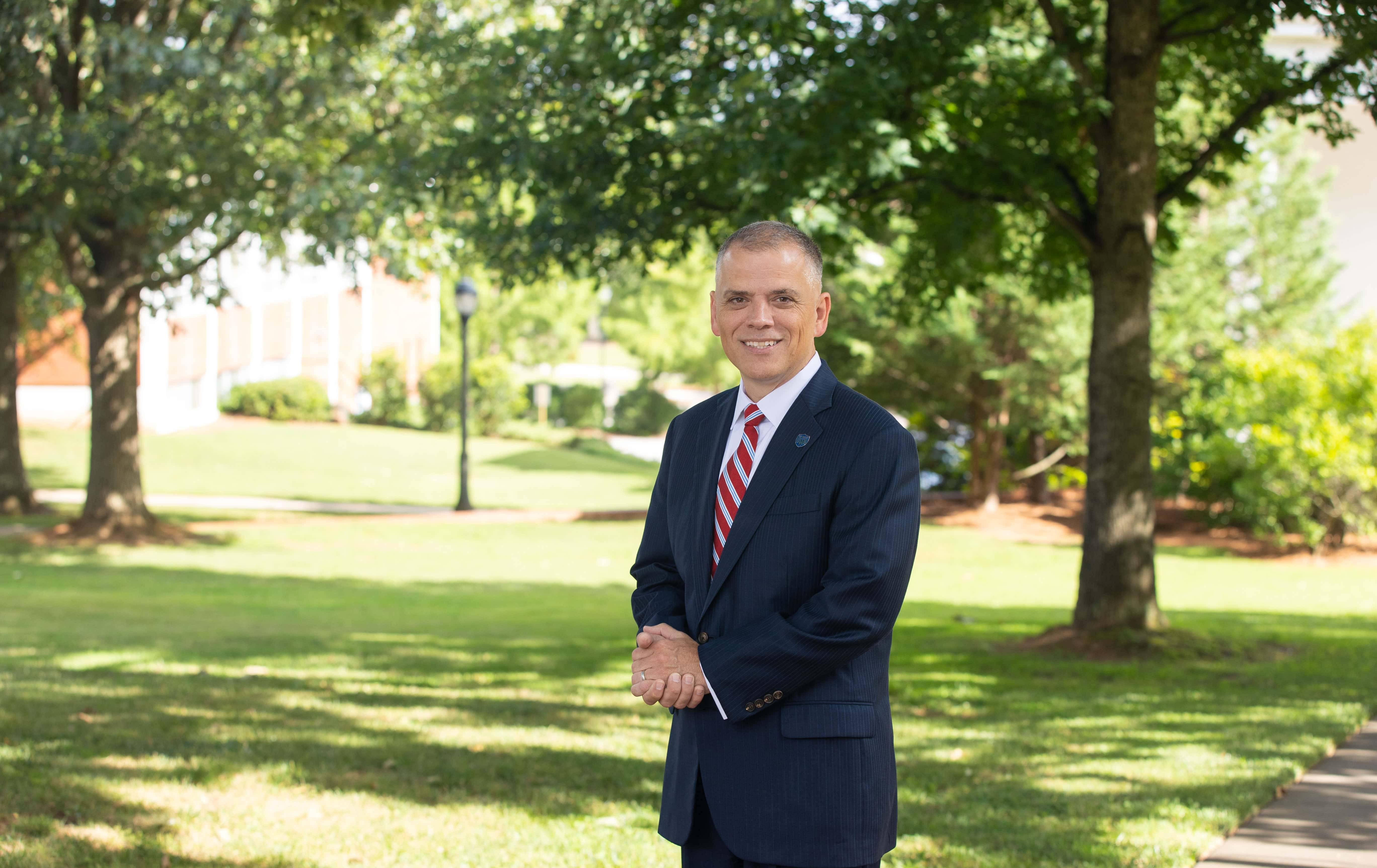 UWG President, Michael Johnson Ph.D., standing for a portrait outside on UWG's campus.