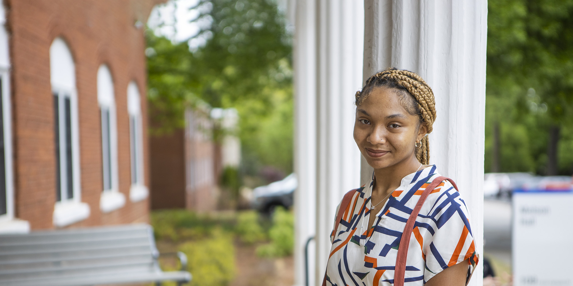 student outside of Melson Hall