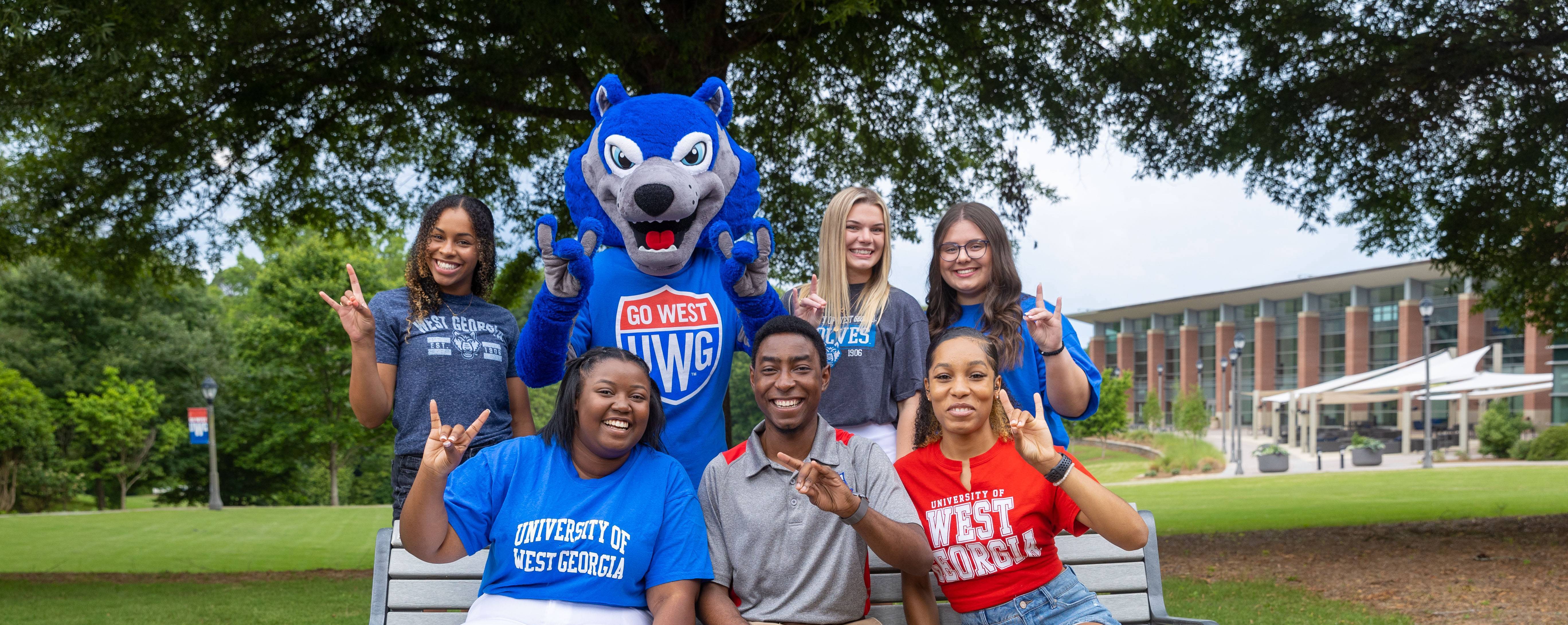 Student Social Media Ambassadors posing with Wolfie mascot