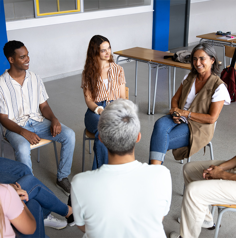 people sitting in a circle with teacher or therapist