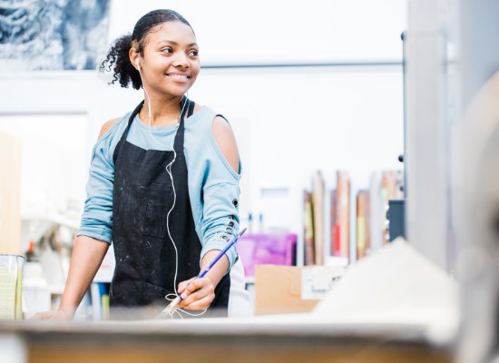 Art student holding a paintbrush.