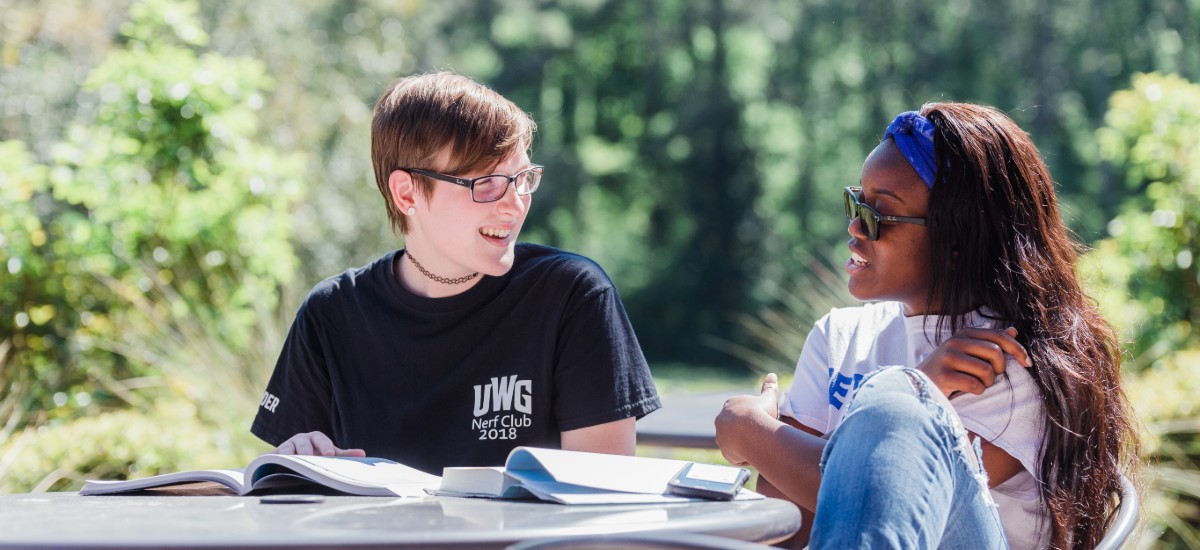 2 students studying outside