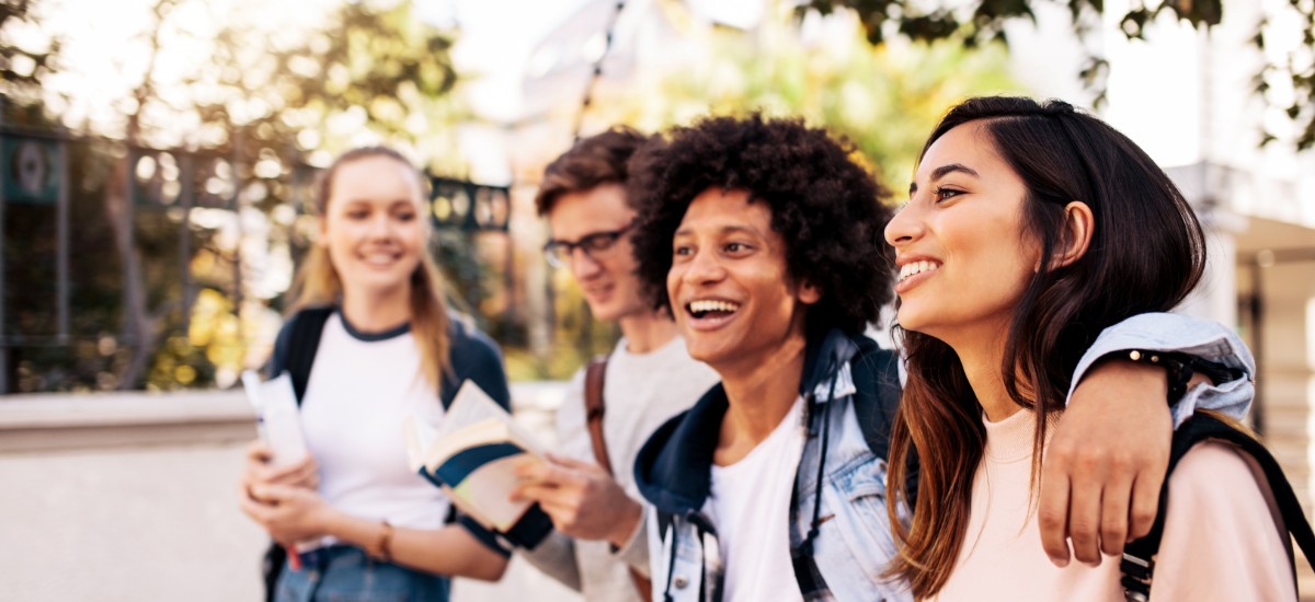 4 students walking outside