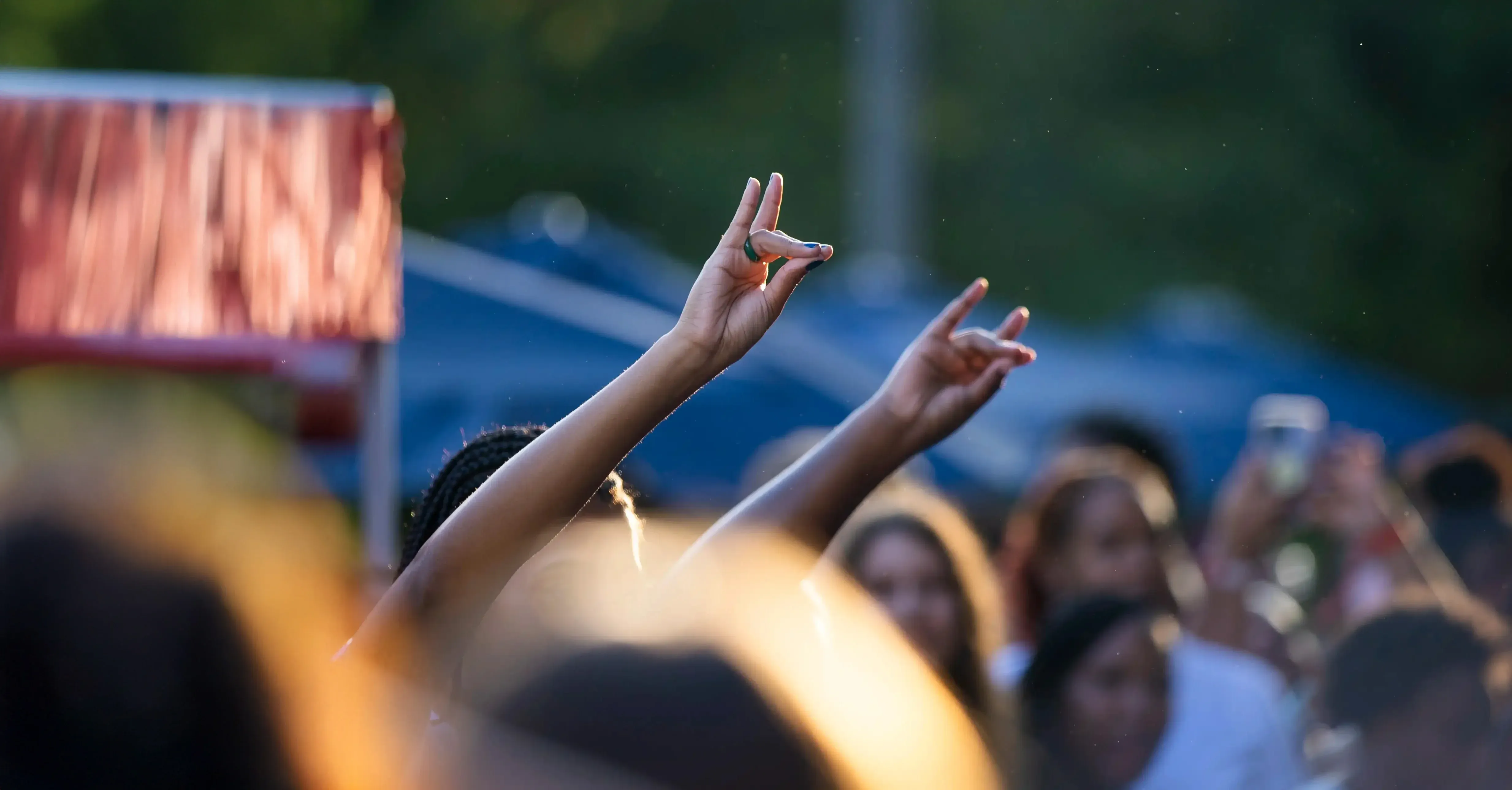 Students gathered in Love Valley with hands up forming the wolf hand sign.