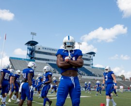 Football players posing on field.