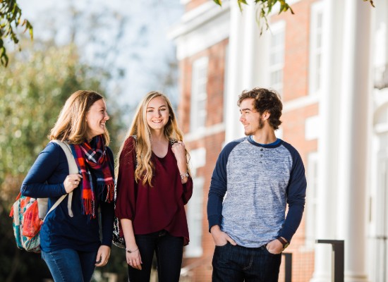 students walking and talking in front of the UWG Newnan campus