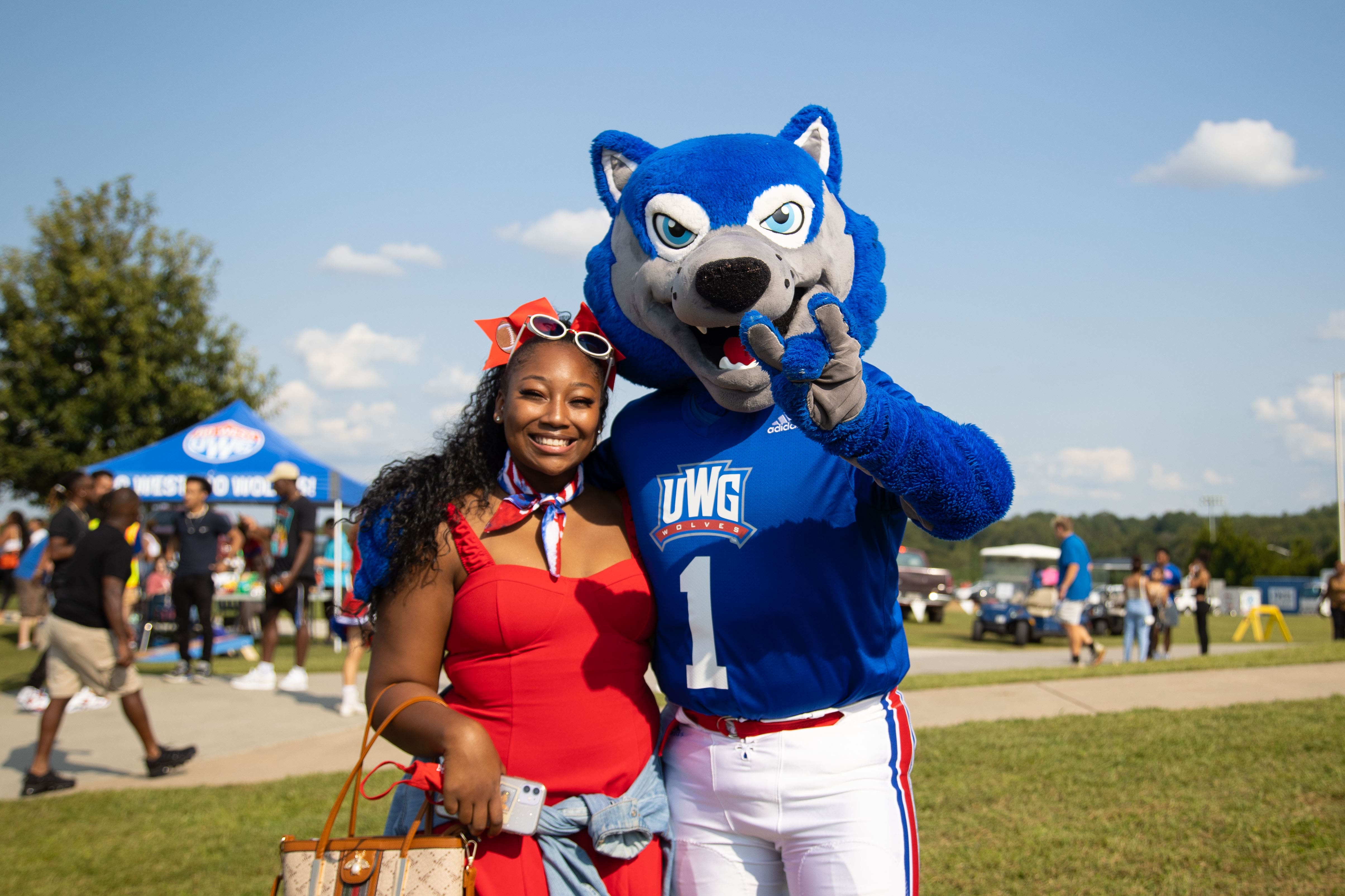 Wolfie with student at football game.