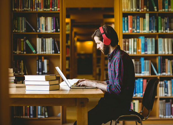 UWG student working on homework in the library.