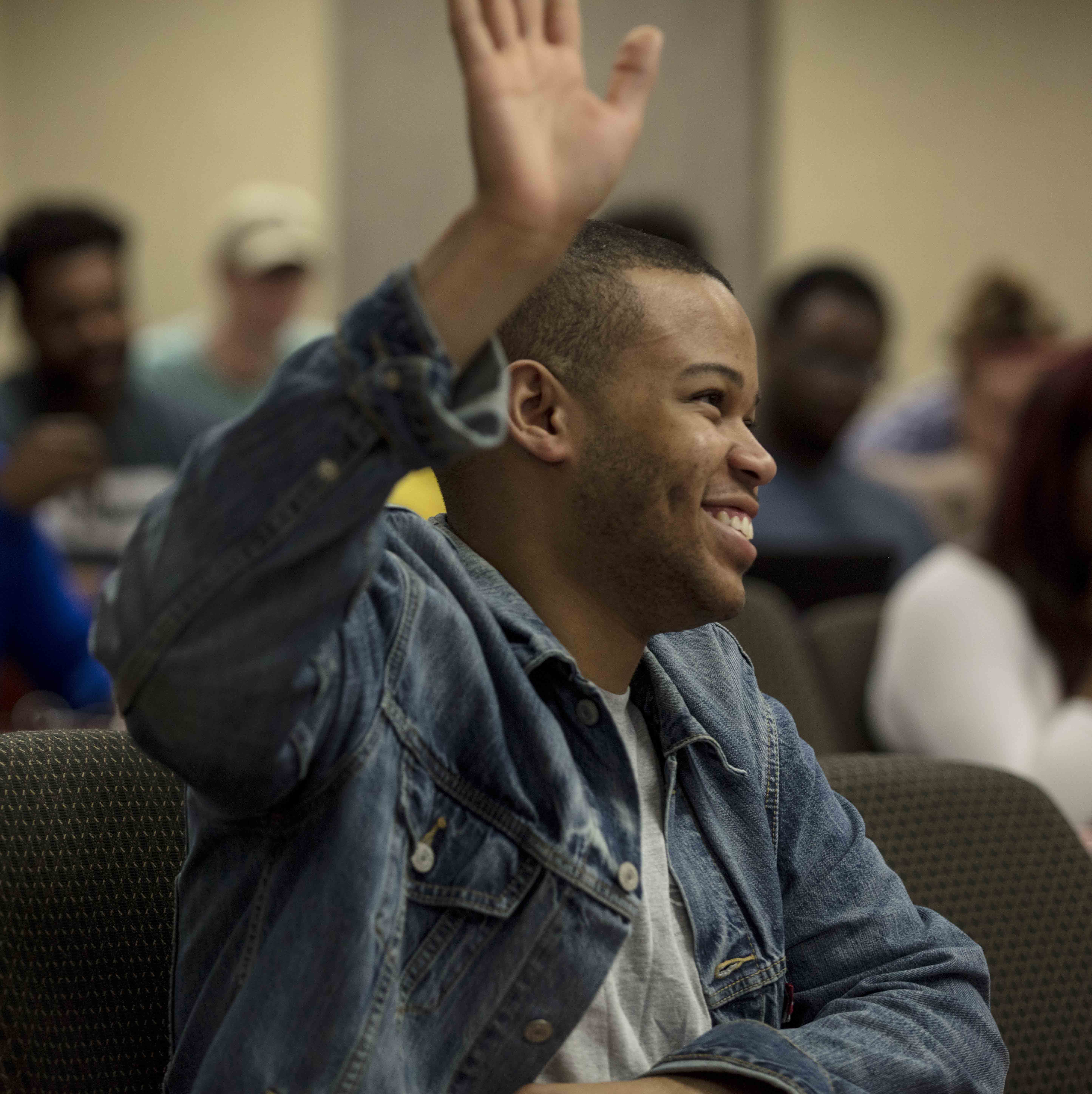 African American male raising his hand