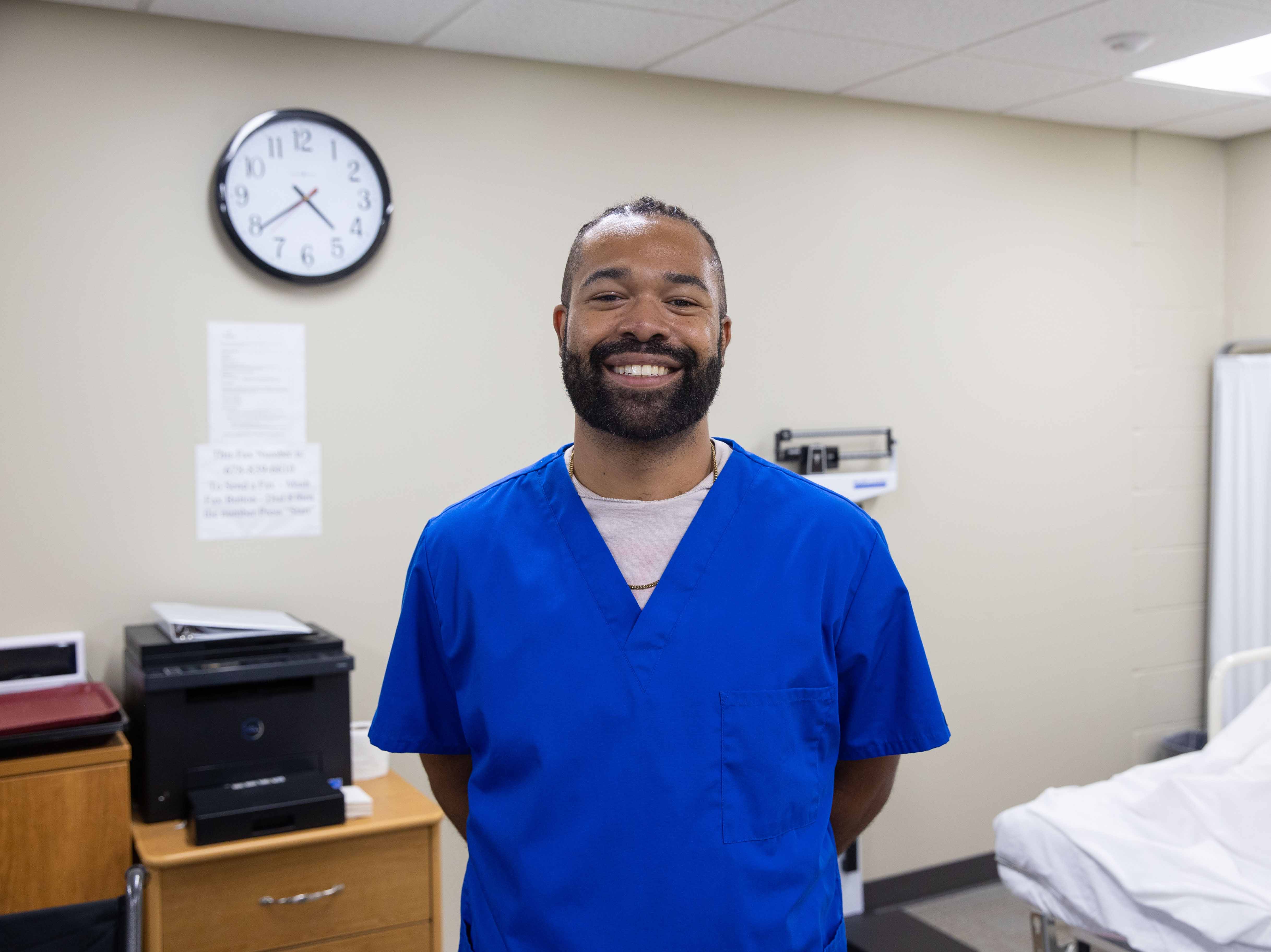 A student in blue scrubs