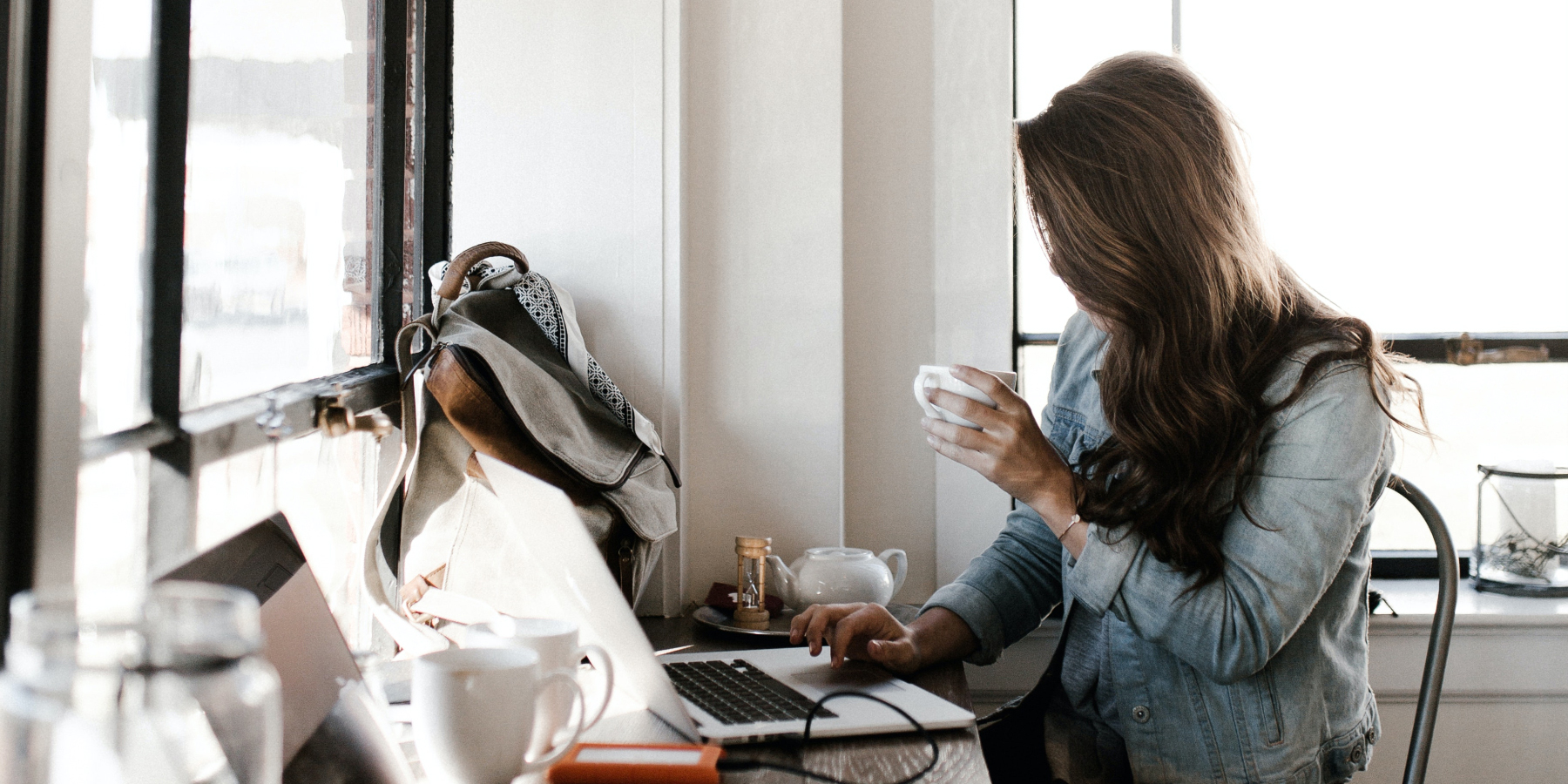 woman sitting drinking coffee and writing