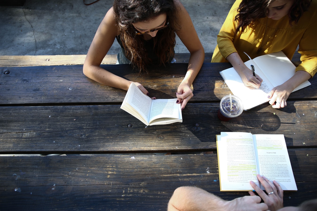 students working in notebooks outside