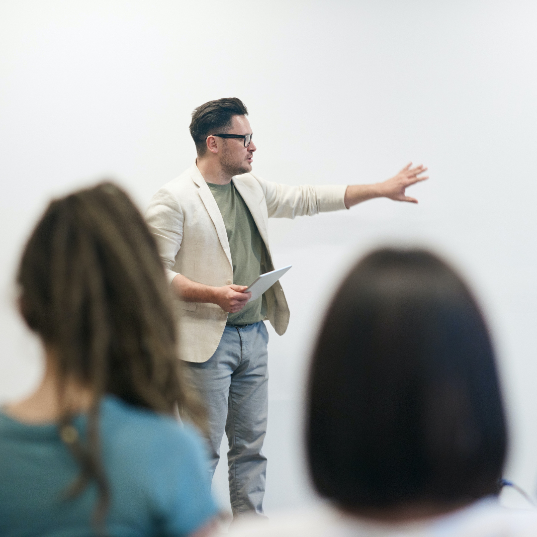 Man talking to a group of students