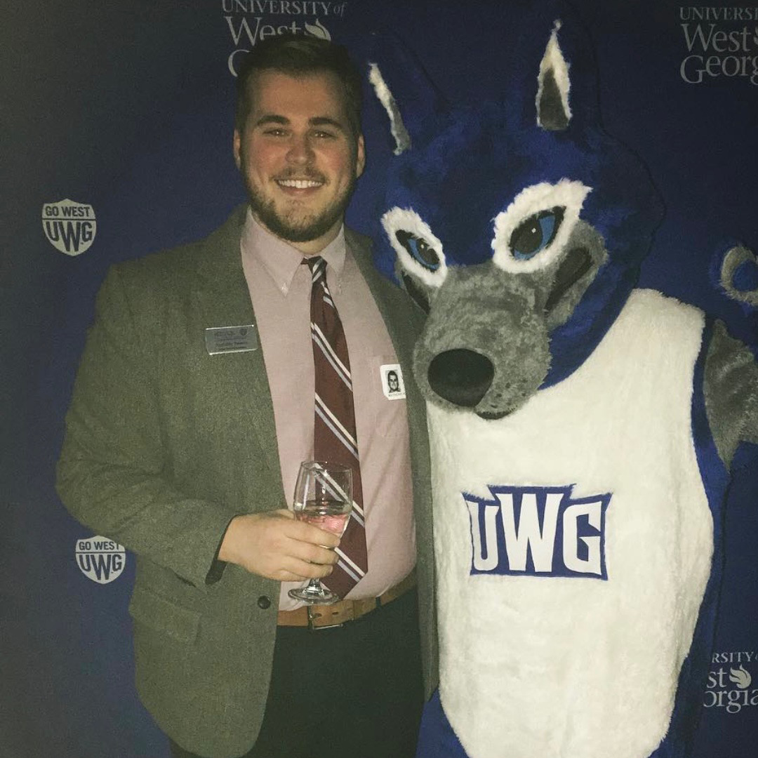 Photo of Anthony standing next to Wolfie
