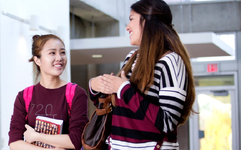 Students walking and talking in the TLC building. 