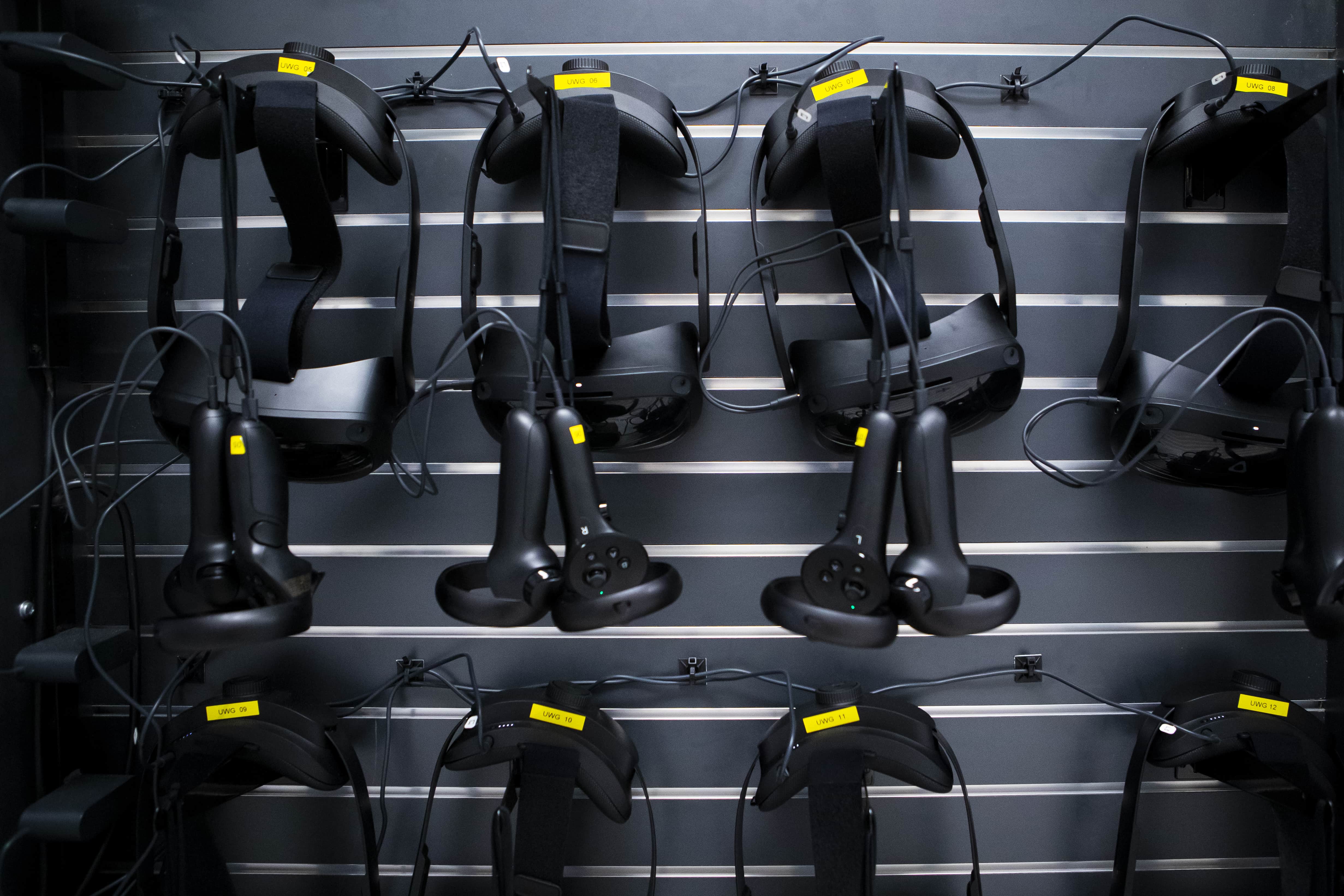 Virtual reality headsets hanging on a wall.