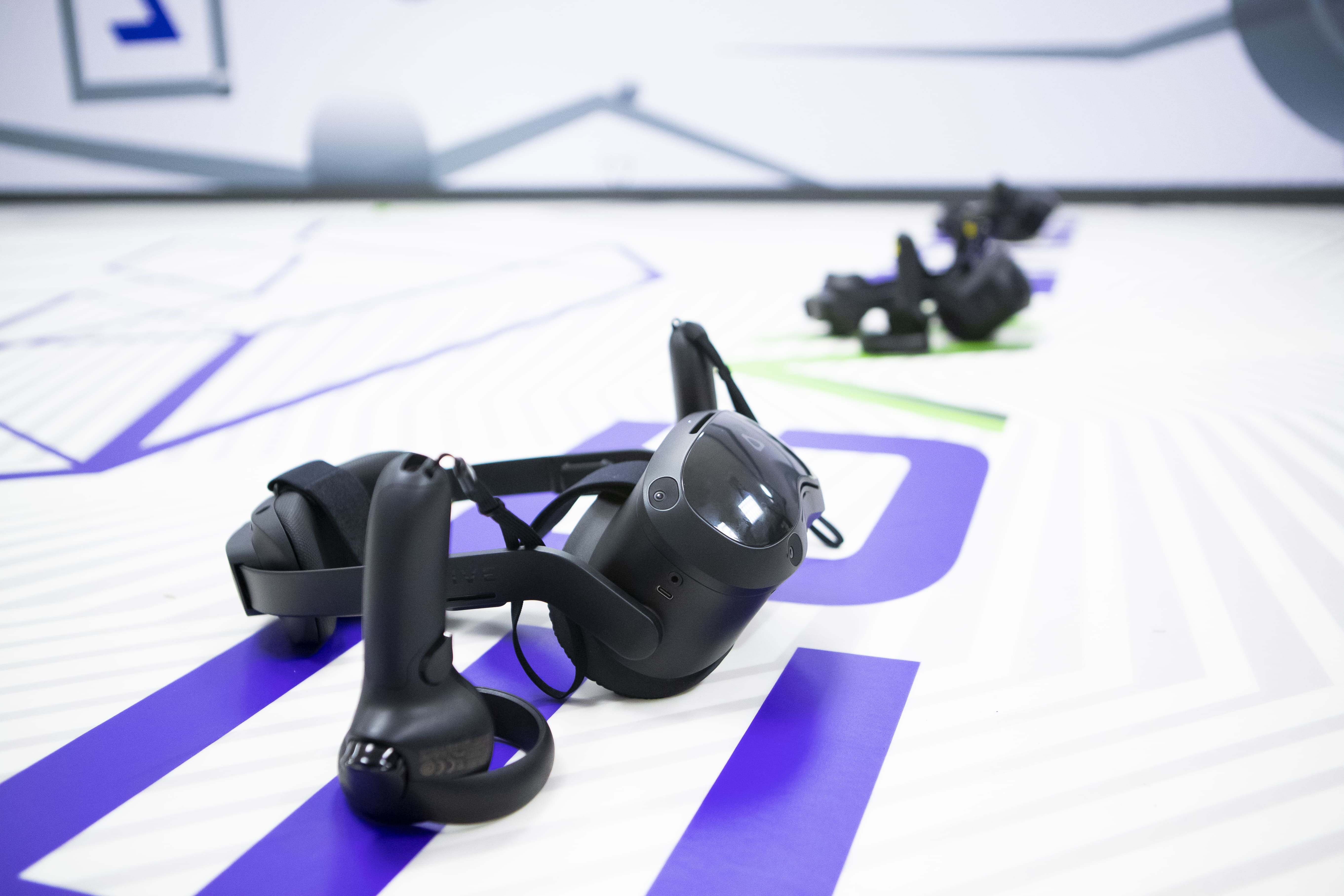 Virtual reality headset and hand controllers sitting in the VR room.