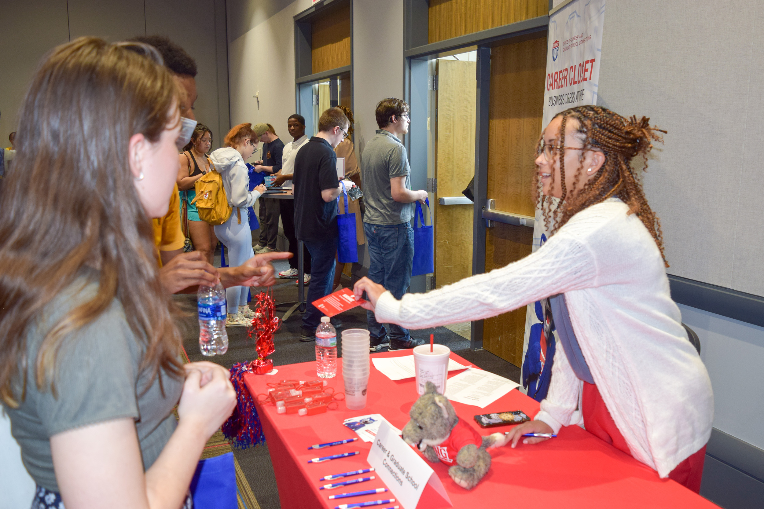 Careers office talking to students at a tabling event handing out information