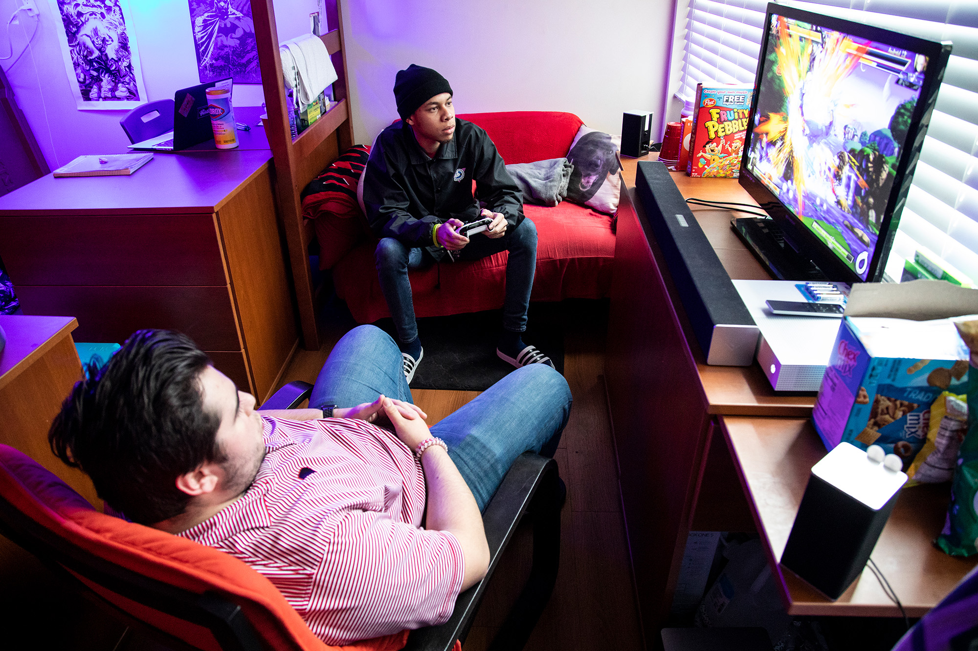 two students playing video games in residential room